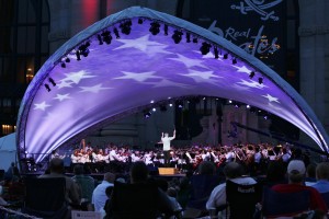The Kansas City Symphony, led by conductor Michael Stern (center stage) performs Tchaikovsky's "1812, Overture solennelle" on stage underneath a star-spangled canopy in front Union Station.