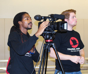 PHOTOS BY BETHANY SHERROW / ASSISTANT NEWS EDITOR Tre Portis (left) assisted in digital media production of the first annual Trading Moon Pow Wow on Saturday in the Student Recreation and Wellness Center. 